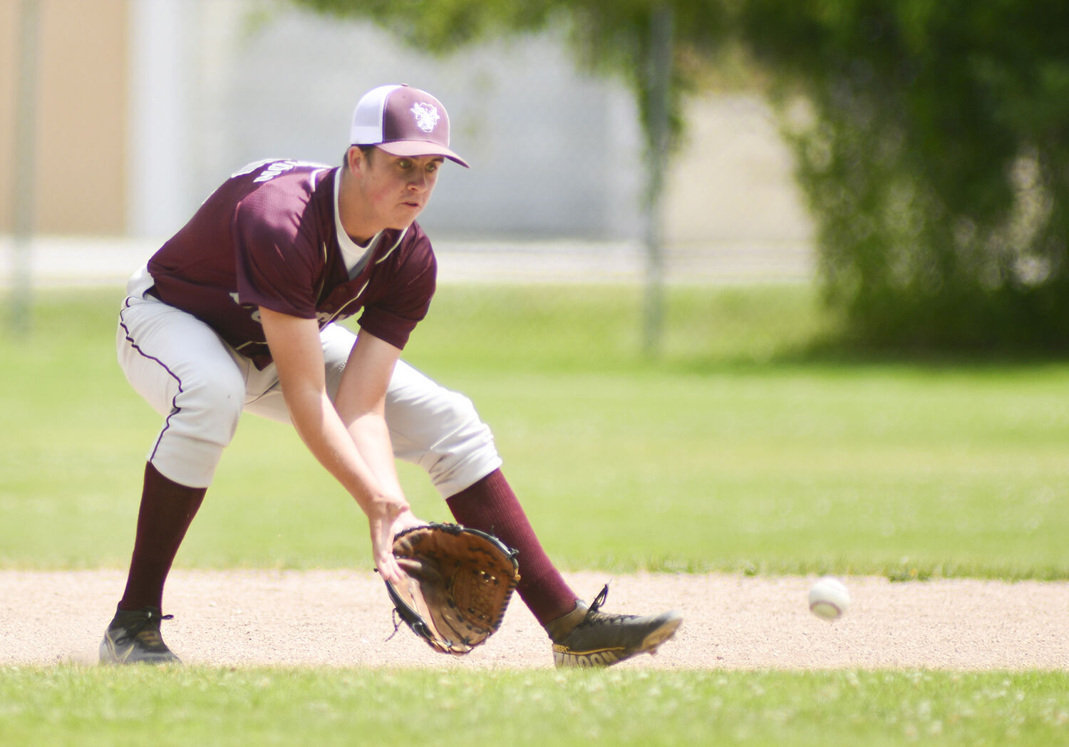 Mason Moon drops down for a ground ball before throwing to first
